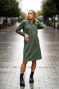 Green cotton-elastane midi dress for women with handmade dragonfly embroidery, bell silhouette and side pockets, designed and made in Lithuania. Comfortable and elegant knitwear dress perfect for autumn and winter season. Žalia trikotažinė suknelė moterims su rankų darbo laumžirgio siuviniu, varpelio siluetu ir kišenėmis – pagaminta Lietuvoje